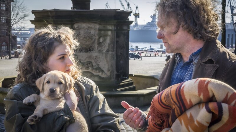 Händler Hans Werkel (Jörg Zuch) will schnell ins Geschäft kommen, doch Lara (Cheyenne Dumat) ist skeptisch. Ist dieser Welpe nicht viel zu jung? – Bild: NDR/​Boris Laewen