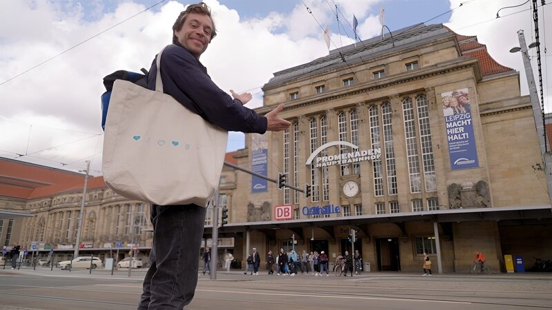 Tobi steht vor dem Leipziger Hauptbahnhof. – Bild: BR/​megaherz gmbh/​David Birzer