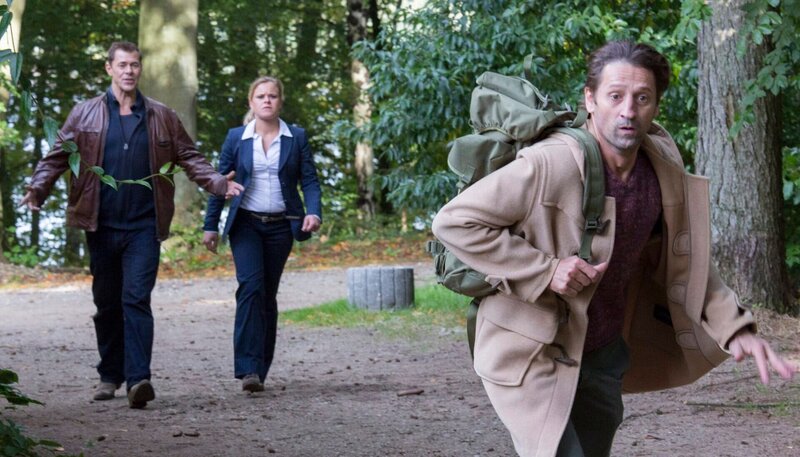 Finn Kiesewetter (Sven Martinek, l.) und Sandra Schwartenbeck (Marie-Luise Schramm, M.) treffen im Wald auf Frank Clasen (Andreas Patton, r.), der vor ihnen davonläuft. – Bild: NDR/​ARD/​Georges Pauly
