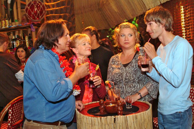 Die Lust am Feiern vergeht Agnes (Susanne Szell, 2.v.r.), als sie mit Helga (Ulrike Mai, 2.v.l.) und Bernd (Volker Herold, l.) in der Tiki-Bar ausgerechnet Boris (Matthias Rott, r.) trifft. Die Plenskes hingegen sind begeistert von dem netten jungen Mann. – Bild: SAT.1 /​ Monika Schürle