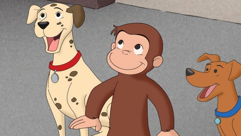 Curious George next to two dogs. – Bild: ORF/​Universal