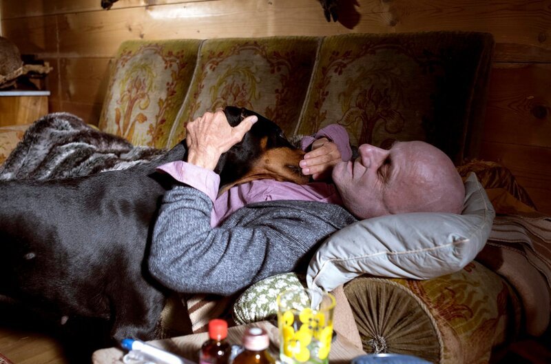 Der kranke Herr Breitbart (Andreas Wellano) schickt den Dobermann los um Hilfe zu holen. – Bild: SWR/​Maria Wiesler
