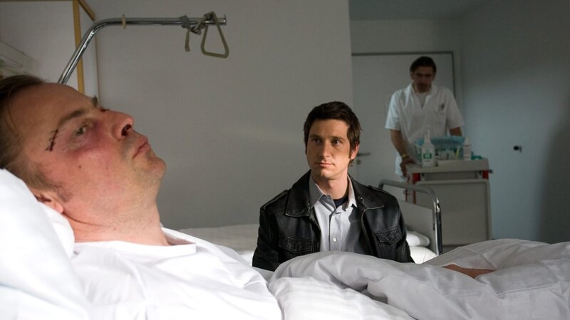 „Soko Kitzbühel“, „Todesängste.“ Sein Wissen um die Ängste der Superreichen hat Dr. Florian Adam zu einem begehrten Psychiater gemacht. In Kitzbühel hat sich die Millionärin Heike Heinrich ihm anvertraut. Da wird Dr. Adam von seinem Bruder Alexander kontaktiert, der eindeutige Kontakte zur süditalienischen Mafia unterhält. als auf den Psychiater ein Attentat verübt wird, sieht es für die SOKO so aus, als ob die Mafia ihn zur Preisgabe von Patienten-Informationen nötigen will. Karin und Klaus wissen, dass dieser Fall eine Nummer zu groß für sie ist. Doch als Klaus’ hochschwangere Freundin in das Fadenkreuz der Mafia gerät, kann er nicht anders, als sich auf ein Spiel mit dem Feuer einzulassen. Im Bild (v.li.): Eckhard Preuss (Dr. Florian Adam), Andreas Kiendl (Klaus Lechner), Tonio Arango (Felice Urso). – Bild: ORF/​BEO-Film/​Stella von Saldern