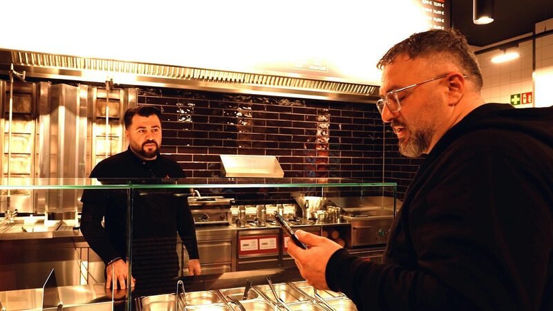 Die Brüder Mehmet Ali (l.) und Gökhan Yesilyurt bei einer Besprechung. +++ Die Verwendung des sendungsbezogenen Materials ist nur mit dem Hinweis und Verlinkung auf RTL+ gestattet. – Bild: RTL /​ TVN FACTUAL ENTERTAINMENT GmbH /​ Brüder, Burger, Business – Geschwister am Limit