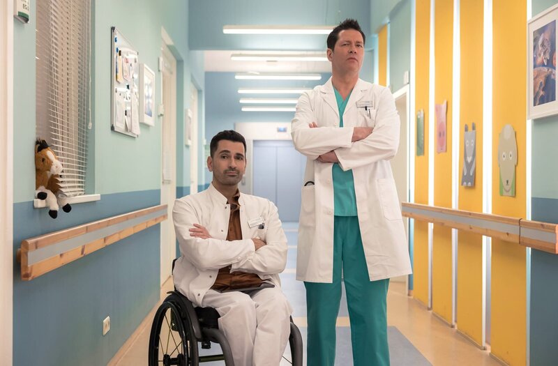 Dr. Philipp Brentano (Thomas Koch, re.) und Dr. Ilay Demir (Tan Caglar, li.) beobachten eine Kollegin und trauen ihren Augen nicht. – Bild: MDR/​Saxonia Media/​Rudolf Wernicke