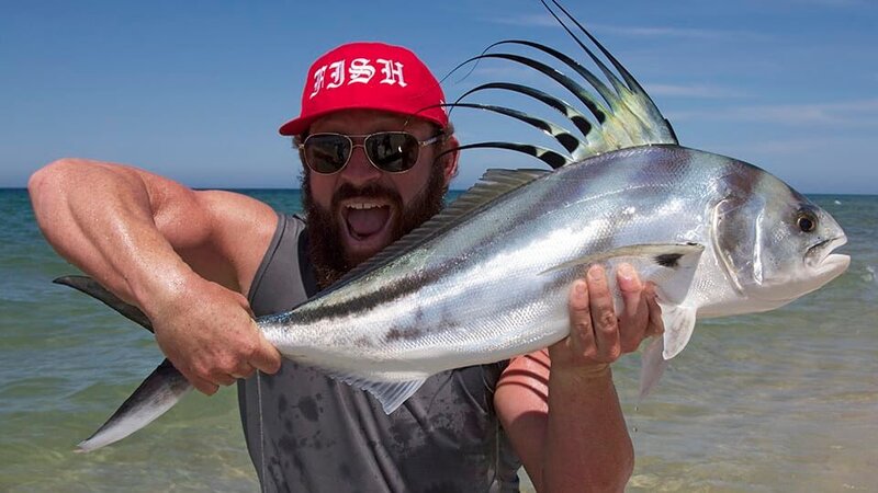 Eric Young catching a fish. – Bild: Warner Bros. Discovery