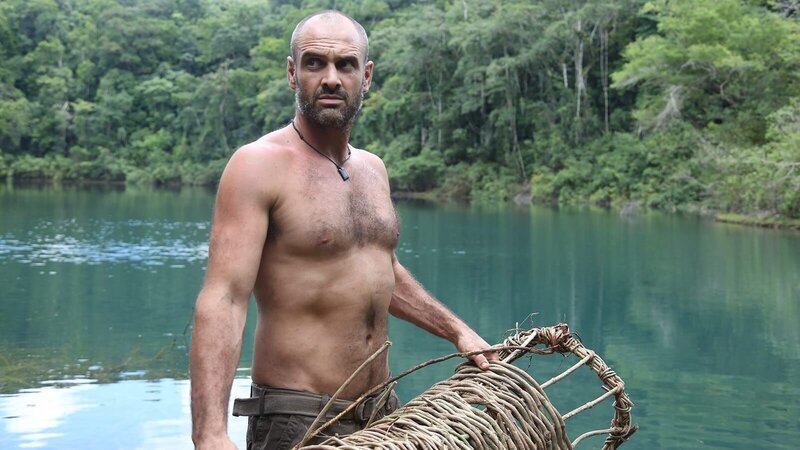 Ed Stafford holding a fashioned fishing basket in both hands on a raft in the Lacandon sink hole in Guatemala. – Bild: Discovery Communications.