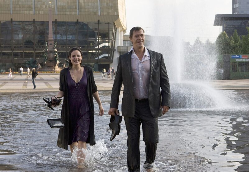 Susanne (Elisabeth Lanz) und Christoph (Sven Martinek) freuen sich über eine spontane Abkühlung nach ihrem Opernbesuch. – Bild: BR/​ARD/​Olaf Raymond Benold