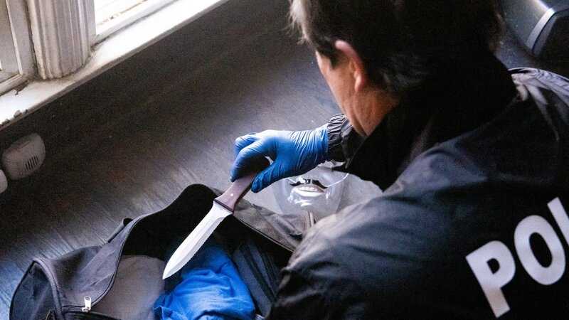 Detective Thomas Small is wearing gloves going through Michael Gargiulo’s duffle bag and finds a knife. – Bild: Discovery Communications, LLC