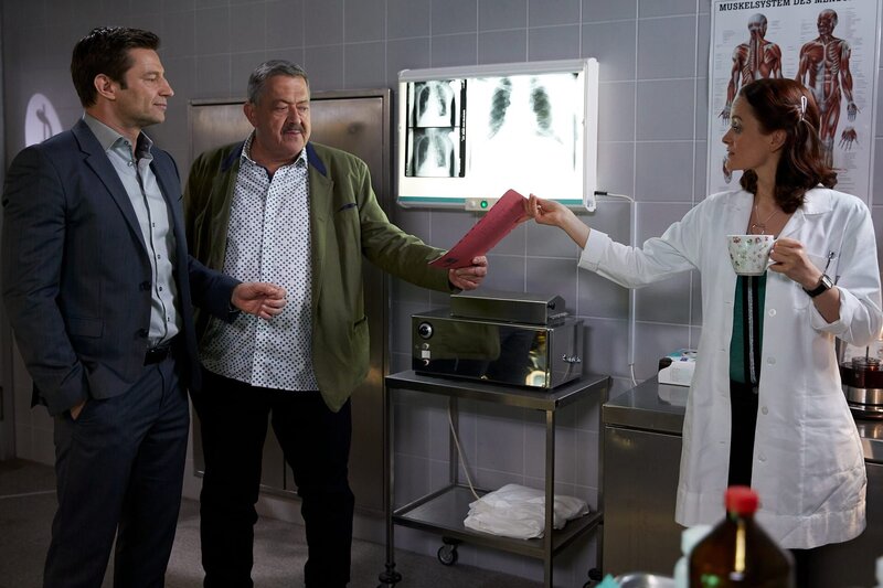 Die Kommissare Hofer (Joseph Hannesschläger, M.) und Hansen (Igor Jefti?, l.) sind gespannt auf die Untersuchungsergebnisse von Pathologin Mai (Sina Wilke, r.). – Bild: ZDF