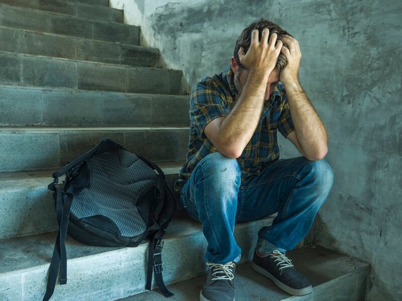 anti sexual discrimination and against homophobia campaign. Young sad and depressed college student man sitting on staircase desperate victim of harassment suffering bullying and abuse – Bild: TheVisualsYouNeed