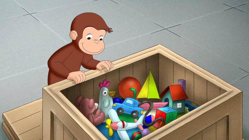 Curious George looking in a box full of toys. – Bild: ORF/​Universal