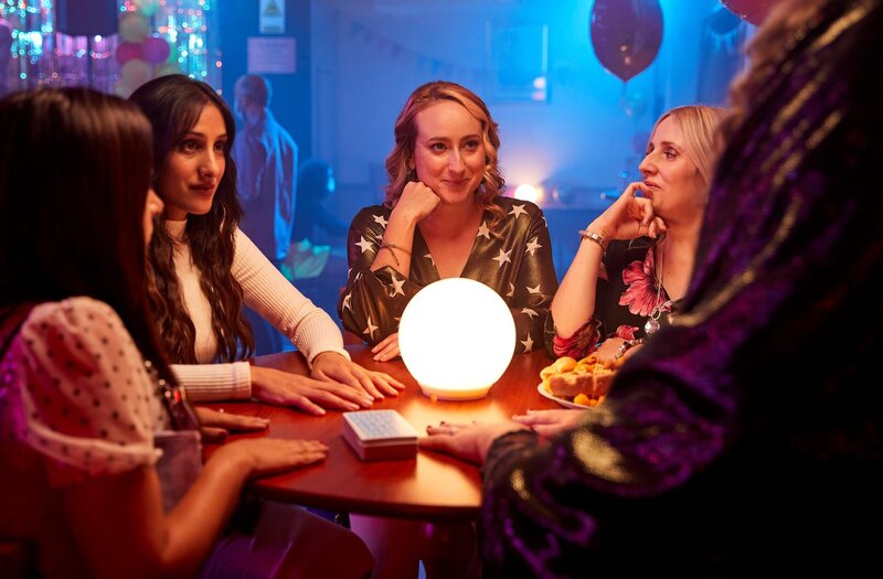 Als sich Ashley (Natalie Davies, l.), Rana (Taj Atwal, 2.v.l.), Toni (Leah Brotherhead, 3.v.l.) und Paula (Sinead Matthews, r.) während der Party zu einer Wahrsagerin setzen, erfahren die Frauen ein Geheimnis, das alle schockiert. – Bild: ZDF