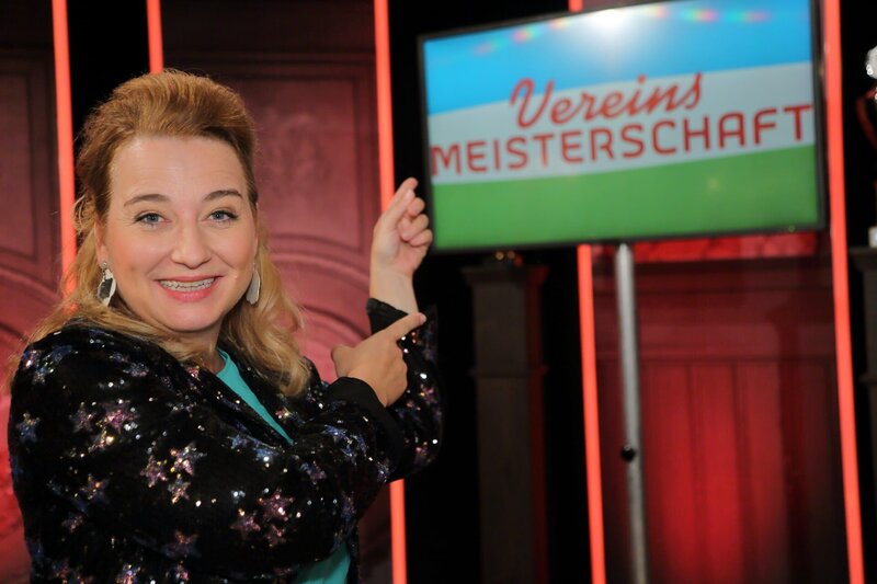 Constanze Lindner.; „Vereinsmeisterschaft“ das große Finale: In der diesjährigen Staffel Vereinsheim Schwabing bekamen neue Talente die Chance, ihr Können unter Beweis zu stellen. In den vergangenen vier Wochen hatte nun die Jury die Aufgabe, die Auftritte der acht Kandidaten und Kandidatinnen zu bewerten und sich zu einigen, wer das Zeug zur Vereinsmeisterin oder zum Vereinsmeister hat. Das Ergebnis wird heute feierlich durch Jury-Chef Hannes Ringlstetter an Moderatorin Constanze Linder (im Bild) übergeben. – Bild: BR/​Andreas Pirchmoser/​Andreas Pirchmoser