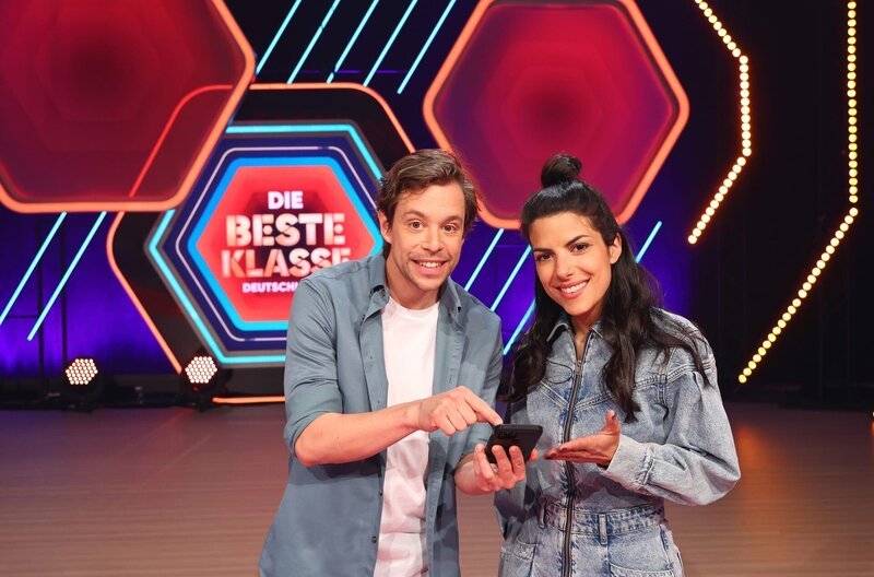 Die Moderatoren Clarissa Corrêa da Silva, genannt Clari, und Tobias Krell, genannt Tobi, freuen sich auf 16 Schulklassen, die ab 13. Mai immer freitags um 19:30 Uhr in vier Wochen-Shows im KiKA aufeinandertreffen. – Bild: HR/​ARD/​KiKA/​Steffen Becker