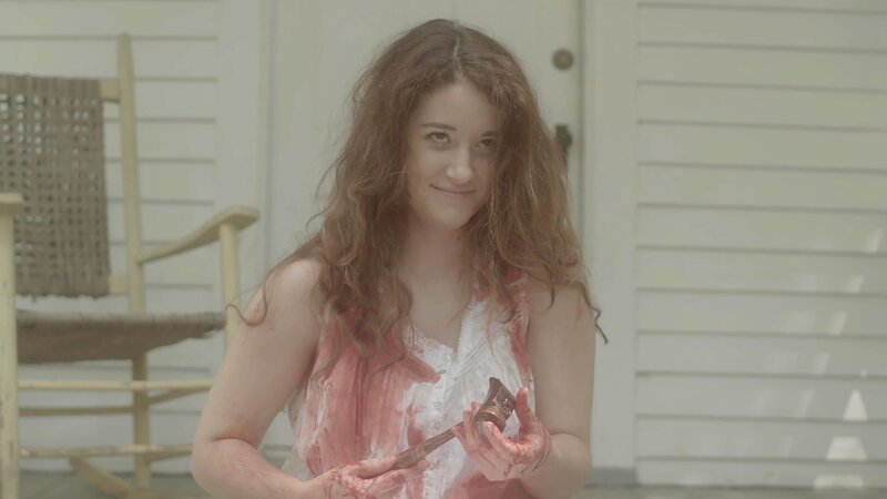 A woman with bloody hands caressing a hammer. – Bild: TLC