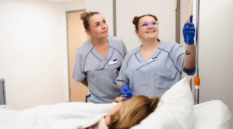 Mal sehen, ob’s tropft: Praxisanleiterin Irene (l.) mit Pflegefachkraft-Azubi Kyra. – Bild: WDR/​Ben Knabe