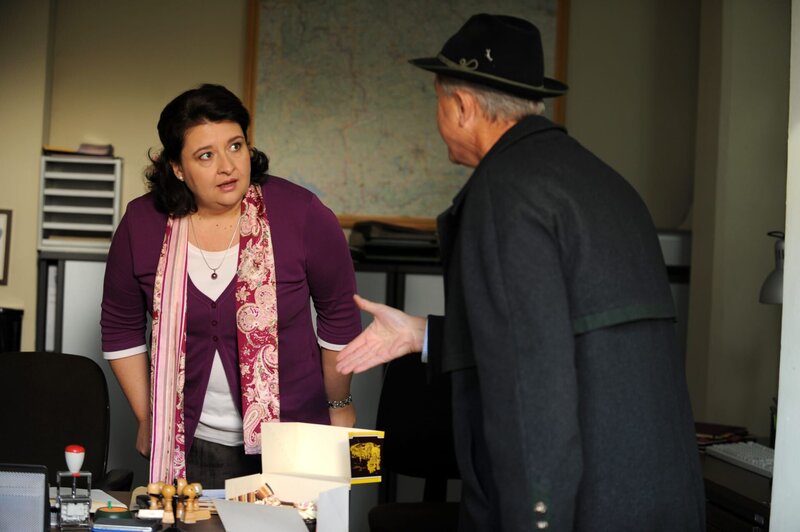 Der Bürgermeister hofft, seine Sekretärin mit Kuchen auf andere Gedanken zu bringen. Von links: Monika Vogl (Christine Reimer) und Bürgermeister Schattenhofer (Werner Rom). – Bild: BR/​Marco Orlando Pichler