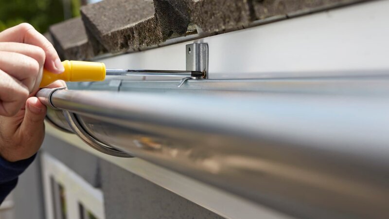 Close Up Of Man Replacing Guttering On Exterior Of House – Bild: Highwaystarz-Photography /​ Getty Images/​iStockphoto /​ GettyImages-477564520_super /​ Highwaystarz-Photography