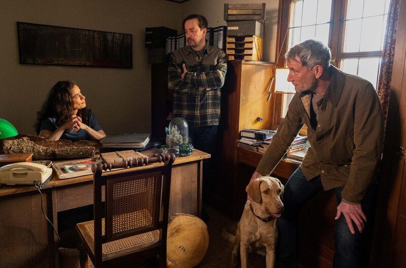 Philip (Heikko Deutschmann, re. ) und Vinzenz (Michael Sideris, mi.) lernen die neue Försterin Dina (Maya Haddad) und ihre Hündin Pari kennen – Bild: ARD/​Maria Wiesler