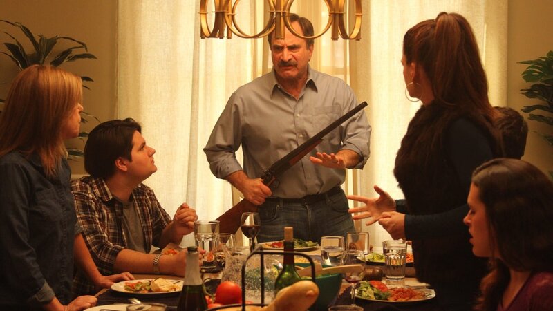 Alfred Ross holding a shot gun at the dinner table while the family fights. – Bild: Discovery Communications