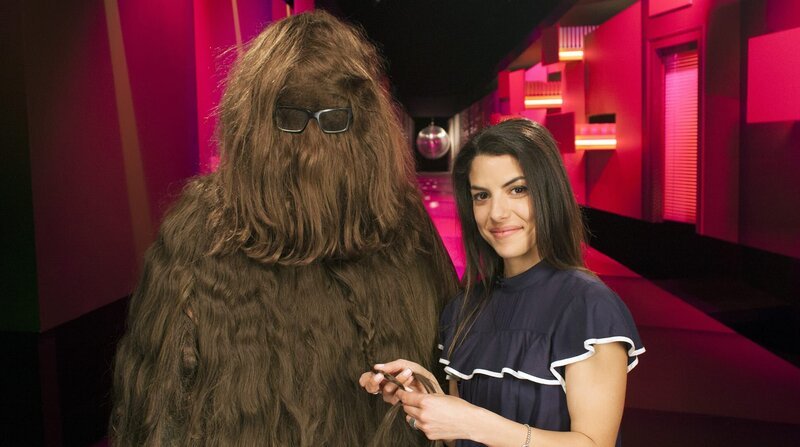 Ein fragwürdiges Geschenk von Ralph für Clarissa sorgt heute im „Wissen macht Ah!“-Studio für eine Überraschung. Ralph hatte Clarissa ein Wachstumsmittel geben wollen und sich dann selber damit eingerieben. Das Mittel fördert aber nicht das Größenwachstum, sondern das der Haare. Und so verschwindet Ralph im Laufe der Sendung unter einem Berg von Haaren. Trotzdem geben Clarissa und Ralph gewohnt souverän die Antwort auf folgende Frage: Wie funktionieren Wunderkerzen? – Bild: BR/​WDR/​Thorsten Schneider