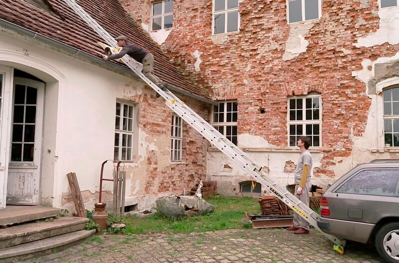Ein altes Haus zu retten – für viele ein Traum, aber auch ein Wagnis. Die Fenster vernagelt, das Dach löchrig, der Garten verwildert. Und dennoch: Es gibt Menschen, die anpacken und längst verfallene Gemäuer mit viel Mut, Zeit und Geld wieder herrichten – u.a. eine Ruine im Oderbruch oder ein Schloss in Polen. – Arkadiusz Gutka und Paweł Kosicki bei Dacharbeiten am Schloss Biecz. – Bild: rbb/​Alexander Huf/​Anna Bilger