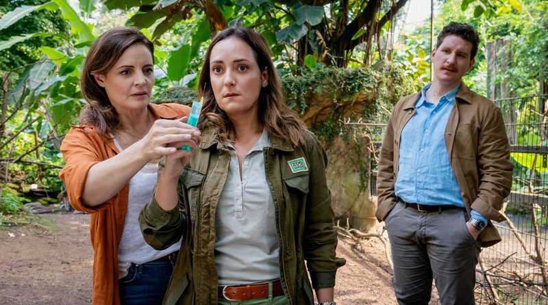 Tierärztin Dr. Suanne Mertens (Elisabeth Lanz, l.) rettet Cheftierärztin Dr. Elif Şahin (Neshe Demir, M.) aus einer gefährlichen Situation: Zoodirektor Jasper Winter (Dominik Weber, r.) beobachtet dies skeptisch. – Bild: ARD/​Steffen Junghans
