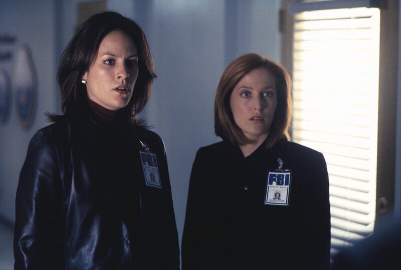 Monica (Annabeth Gish, l.) und Scully (Gillian Anderson, r.) erfahren vom Tod des Mitarbeiters Carl Wormus, Abteilungsleiter der Umweltschutzbehörde. Er soll mit seinem Wagen in den Potomac gestürzt und ertrunken sein. – Bild: Twentieth Century Fox Film Corporation
