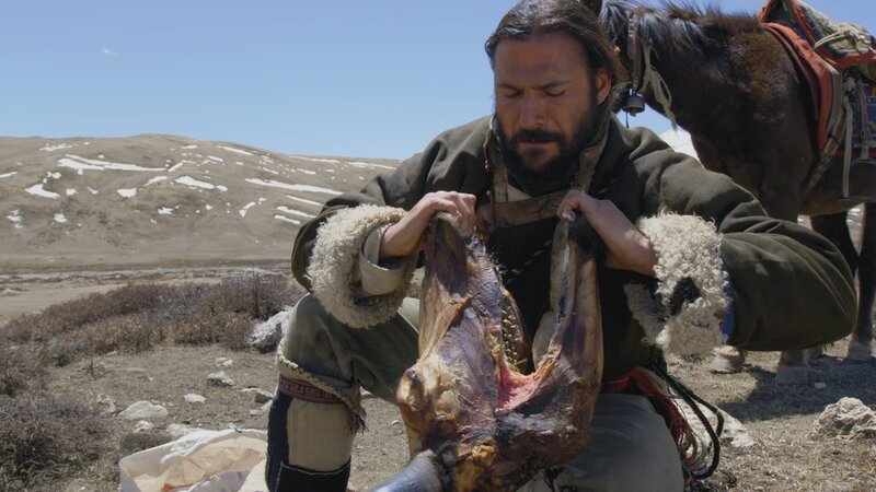 Hazen opening the mouth of a boiled yak head. – Bild: National Geographic/​Stuart Trowell