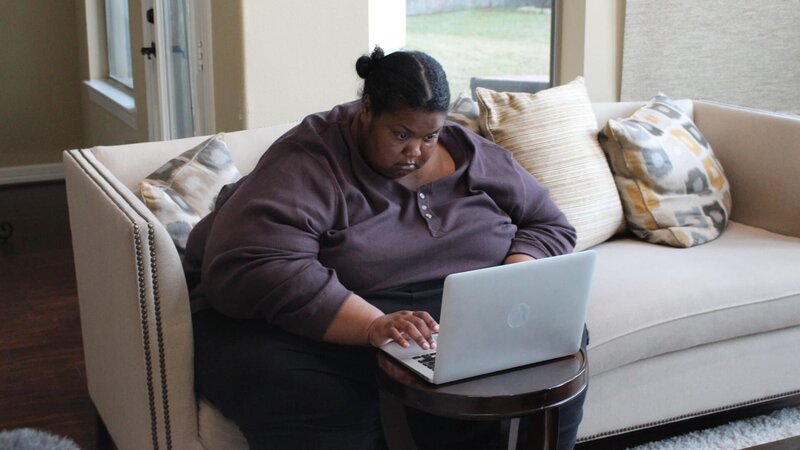Kelly browses the computer while sitting on couch – Bild: Discovery Communications