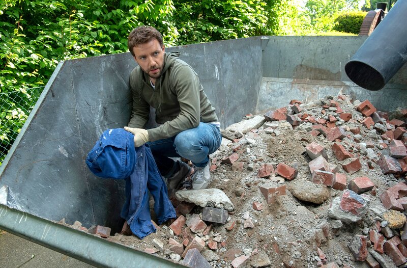Gregor (Jonas Minthe) findet im Schuttcontainer ein wichtiges Beweisstück. – Bild: ARD/​Thorsten Jander