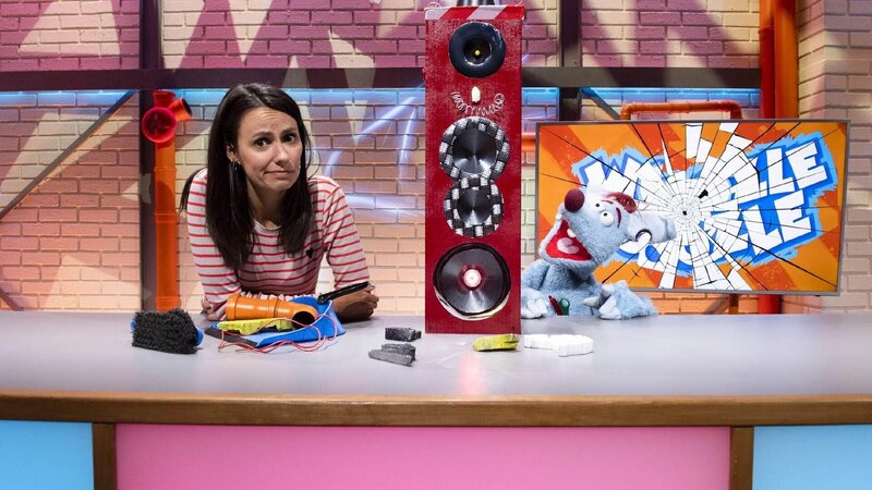 Woozle (re.) und Maria (li.) haben mit dem Lärm einer nahegelegenen Baustelle zu kämpfen. Als Woozle Krach mit Krach schlagen will, führt das zur Verwüstung des halben Studios. Die Studioleitung ist sauer und nutzt ausgerechnet eine von Woozles eigenen Erfindungen aus, um selbst mal ein bisschen Ruhe vor dem verrückten Erfinder zu haben. – Bild: Annette Etges/​SUPER RTL