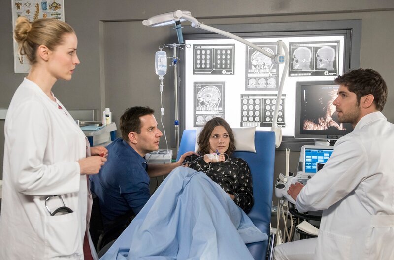 Julia (Mirka Pigulla, l.) und Niklas (Roy Peter Link, r.) müssen dem besorgten Paar, Jonas (Ole Eisfeld) und Lea Metzer (Anna Bertheau) mitteilen, dass ihr Baby in ernster Gefahr schwebt. – Bild: ARD/​Jens-Ulrich Koch