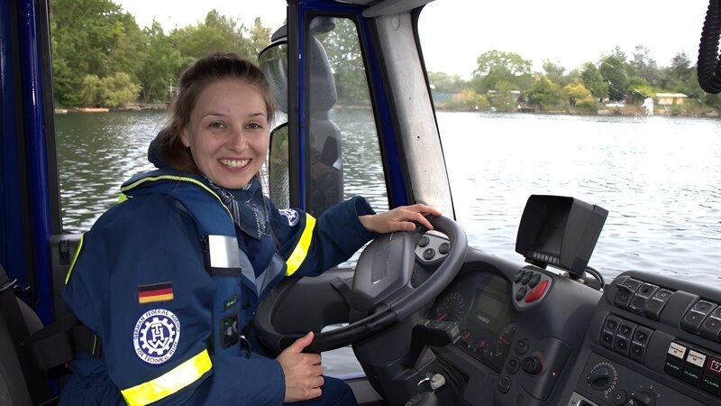 Marina testet das Amphibienfahrzeug des TWH auf der Straße und im Wasser. – Bild: BR/​megaherz GmbH/​Hans-Florian Hopfner /​ KiKA
