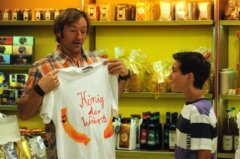 Felix hat sich für Gregor ein besonderes Geschenk überlegt. Von links: Gregor Brunner (Holger M. Wilhelm) und Felix Kramer (Shayan Hartmann). – Bild: BR/​Marco Orlando Pichler