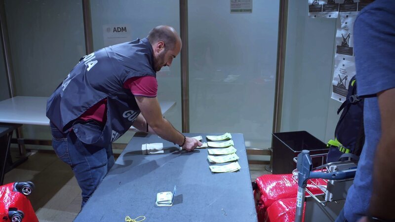 Grenzbeamter zählt beschlagnahmtes Geld – Bild: Warner Bros. Discovery