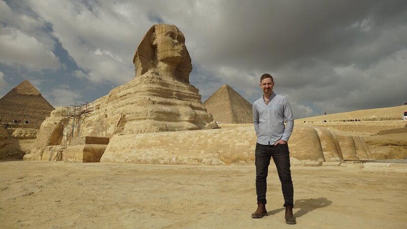Gizeh, Ägypten – Der Ägyptologe Chris Naunton an der Großen Sphinx von Gizeh. – Bild: Windfall Films/​Ben Holgate