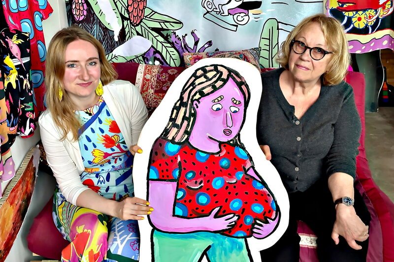 Kulturplatz – Mutter mit 17 – Teenager-Schwangerschaft damals und heute. Wanda Dufner und Elisabeth Meister sitzen mit der Comicfigur einer schwangeren Frau auf dem Sofa. – Bild: SRF1