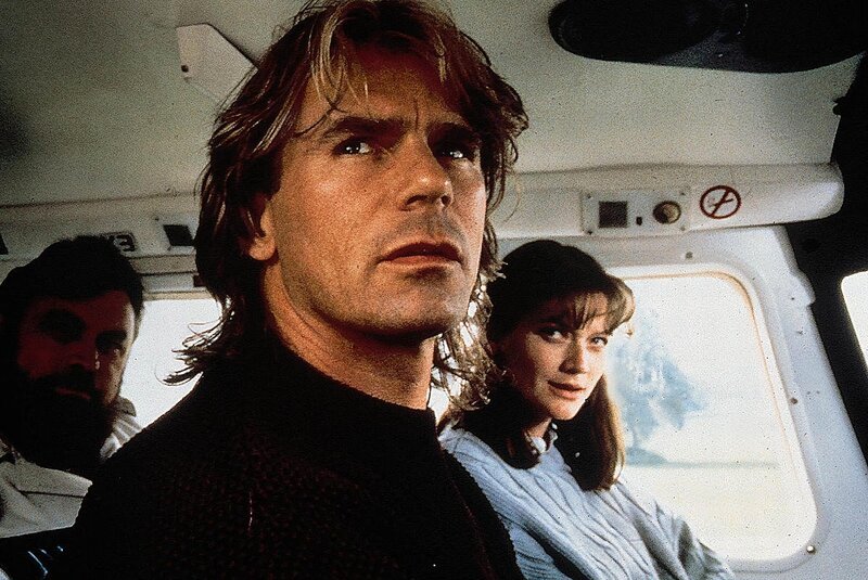 Professor Atticus (Brian Blessed) hat es sich in den Kopf gesetzt, das Rätsel um die versunkene Stadt Atlantis zu lüften. Er bittet seinen ehemaligen Studenten MacGyver (Richard Dean Anderson) um Hilfe. Zusammen mit Kelly (Sophie Ward) fliegen sie zurück nach Thera, um mit der Fackel, einem Medaillon und einer Truhe, den Schatz von Atlantis zu heben. – Bild: Nitro