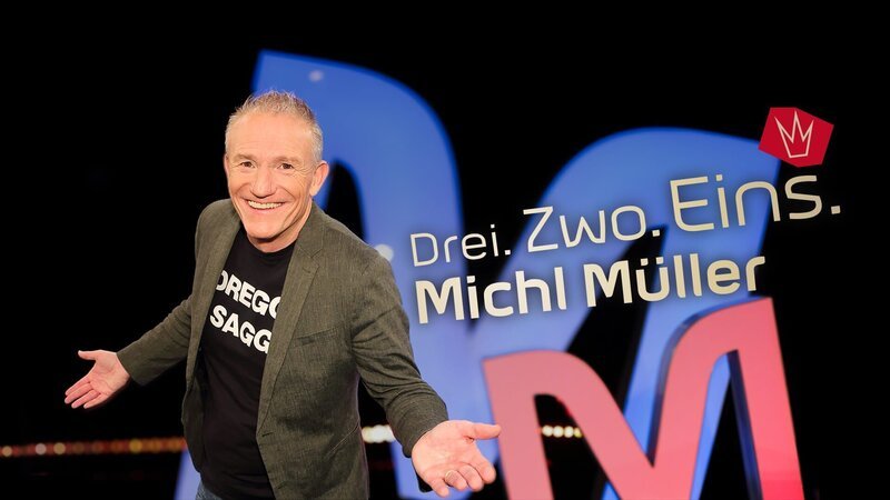 Key Visual Sendereihenbild mit Typo zu „Drei. Zwo. Eins. Michl Müller“. Pointiert und süffisant kommentiert der selbsternannte „Dreggsagg“ in seiner satirischen Chart-Show „Drei. Zwo. Eins. Michl Müller“ die aktuelle Nachrichtenwelt aus Politik, Boulevard und Gesellschaft. – Bild: BR/​Andreas Pirchmoser