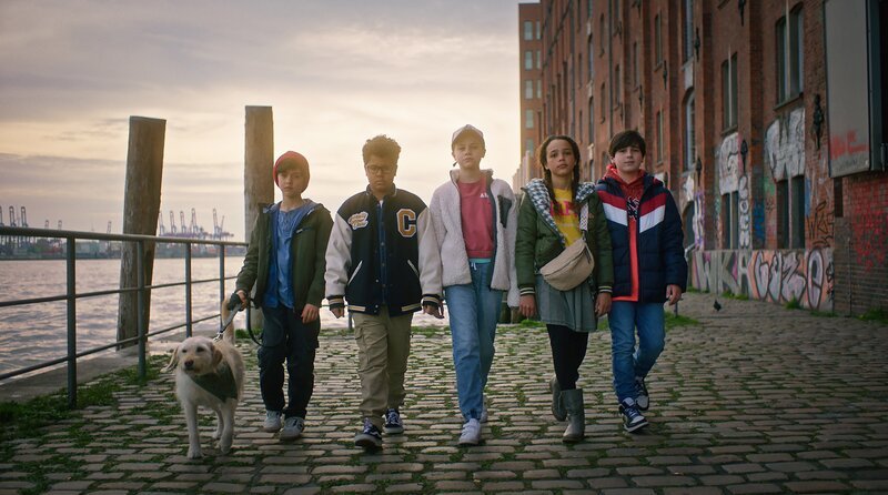 Der erste Fall ist gelöst! Selbstbewusst zeigen sich Piet (Noah Lusander) mit Hund Bagel, Kofi (Mathieu Noël), Malin (Ida Carlo), Taara (Josefine Maxima) und Jules (Tibet Held). – Bild: NDR