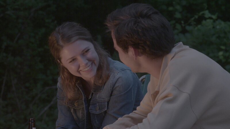 A boy and girl sitting around a campfire. – Bild: Discovery Communications, Inc.