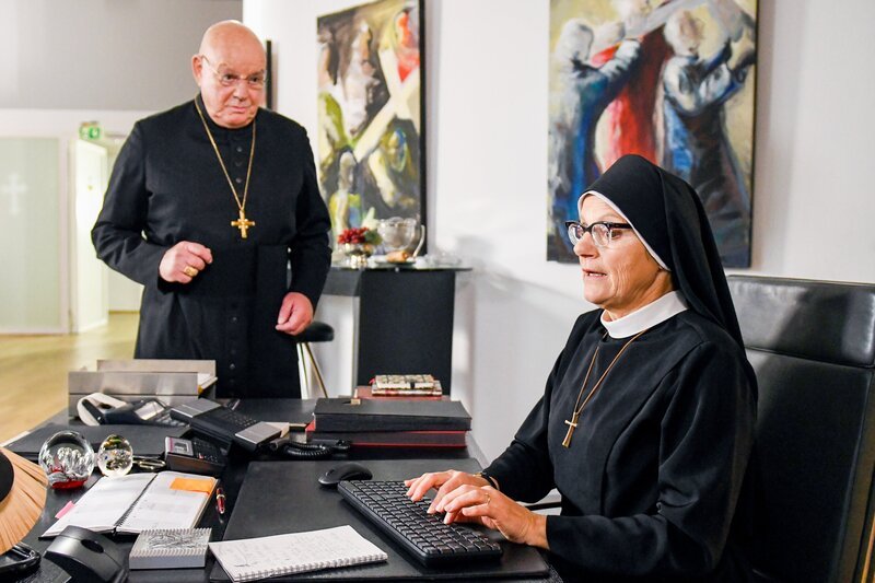 Der Weihbischof (Wolfgang Böck) ist begeistert von Schwester Hildegards (Andrea Sihler) Liebesroman. – Bild: ORF/​Beta Film/​ARD/​Barbara Bauriedl