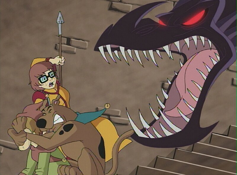 (V.li.) Velma, Shaggy und Scooby-Doo besuchen einen Jahrmarkt mit Ritterspielen. Plötzlich taucht ein Drache auf, der dem Vergnügen ein jähes Ende bereitet. – Bild: SUPER RTL