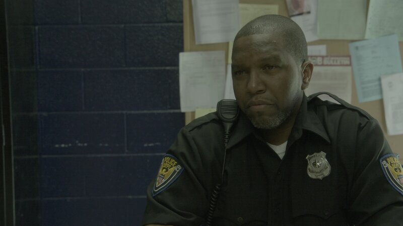 An officer stares. – Bild: Discovery Communications