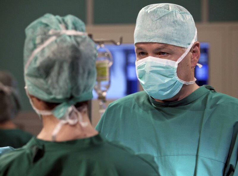 Dr. Roland Heilmann (Thomas Rühmann, rechts) und Dr. Elena Eichhorn (Cheryl Shepard) operieren Volker Angermann. Der Bauleiter wurde auf der Baustelle von Dämmplatten begraben und hat eine Milzruptur erlitten. – Bild: MDR/​Wernicke