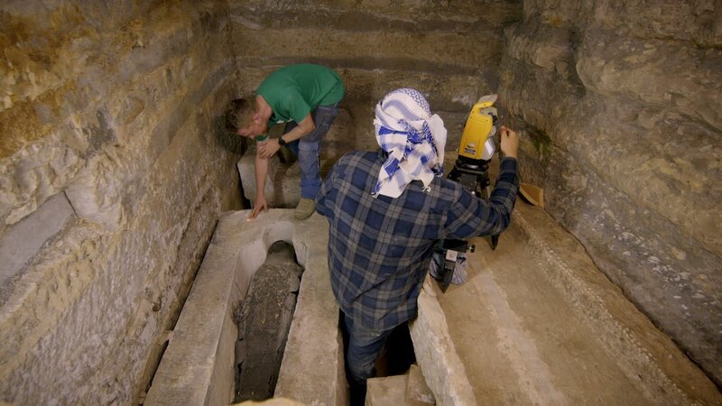 Dr. Matthias Lang (L) und Philippe Kluge (R) führen einen 3D-Laserscan der Grabkammer der beiden Priester durch, nachdem der Deckel von Tjanimit entfernt wurde. Das Team scannt in jeder Phase der Ausgrabung, um eine visuelle Zeitleiste ihres Fortschritts zu erstellen. – Bild: National Geographic/​Will Churchill