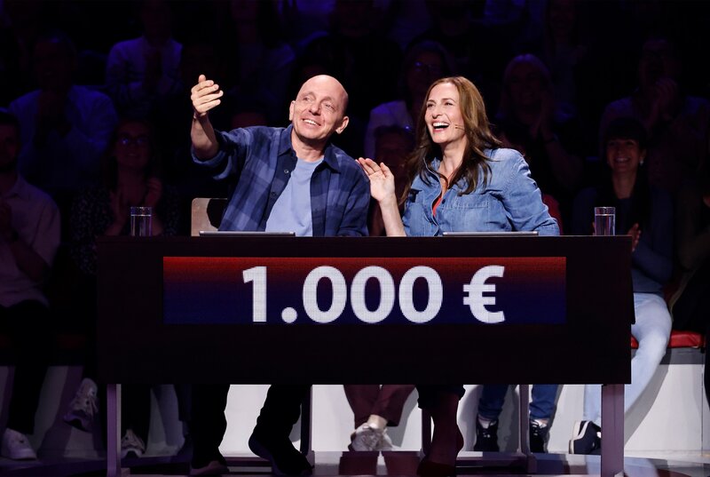 Rateteam-Kapitän Bernhard Hoëcker (l.) mit Schauspielerin Ulrike Frank (r.). – Bild: ARD/​NDR/​UFA SHOW & FACTUAL/​Morris Mac Matzen
