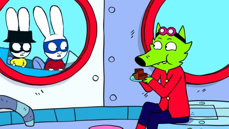 Professor Wolf (r.) hat sich mit Hilfe der gestohlenen Schlüssel in der Superhelden-Basis von Superhase (M.) und Captain Hase (l.) verschanzt und genießt seinen Triumph genüsslich bei einem Stück Kuchen. – Bild: ZDF und GO-N Productions